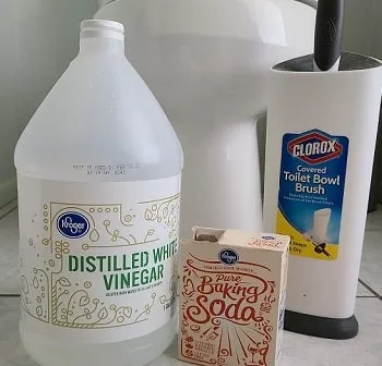 dirty toilet and supplies for cleaning a toilet